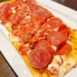 Closeup,Of,Long,Rectangular,Flatbread,Pepperoni,Pizza,On,White,Plate